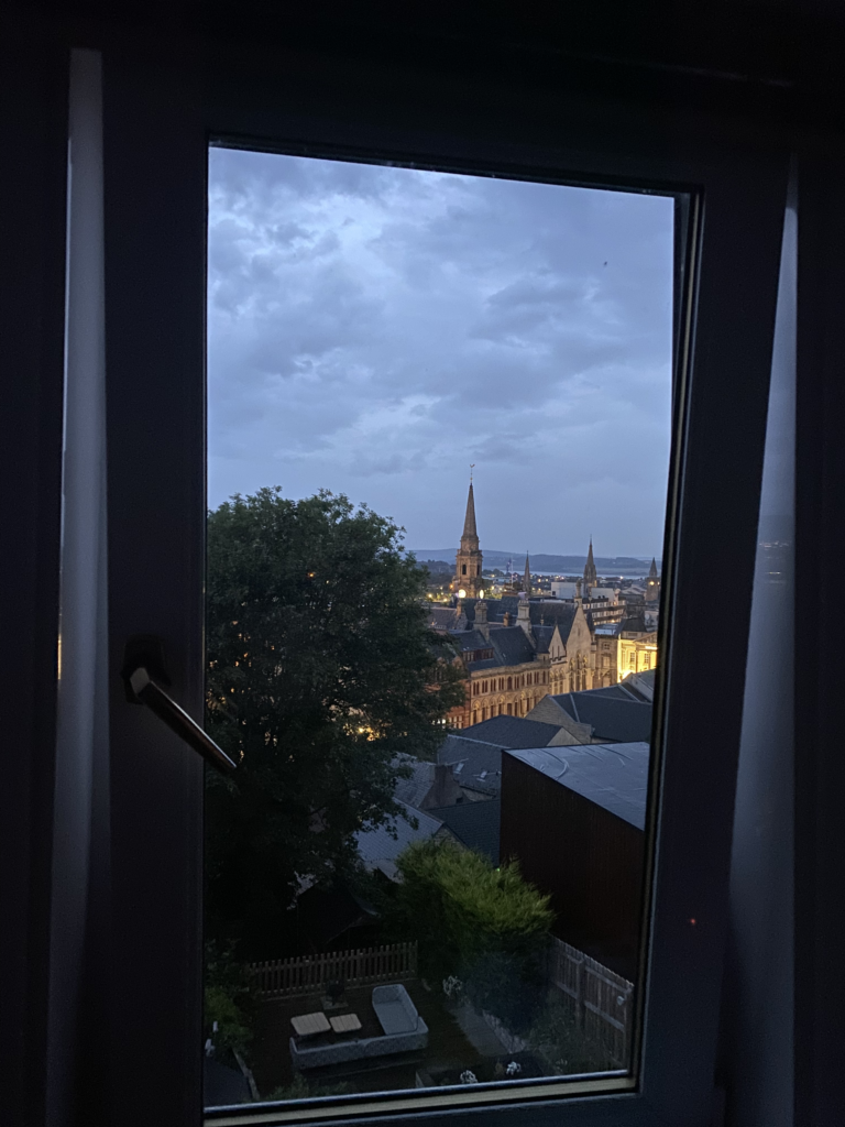 view through window of Inverness city lit up at night.